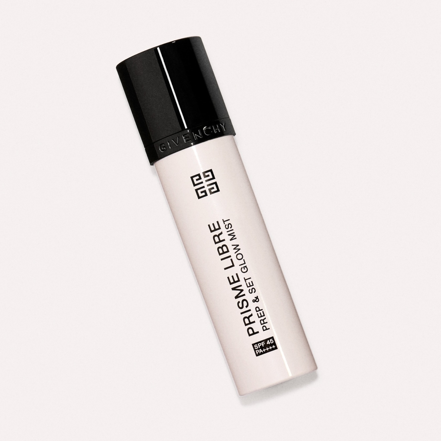 De Givenchy Prisme Libre Prep & Set Glow Mist in een witte flacon met een zwarte dop, ideaal om de huid voor te bereiden en te fixeren met een stralende finish.