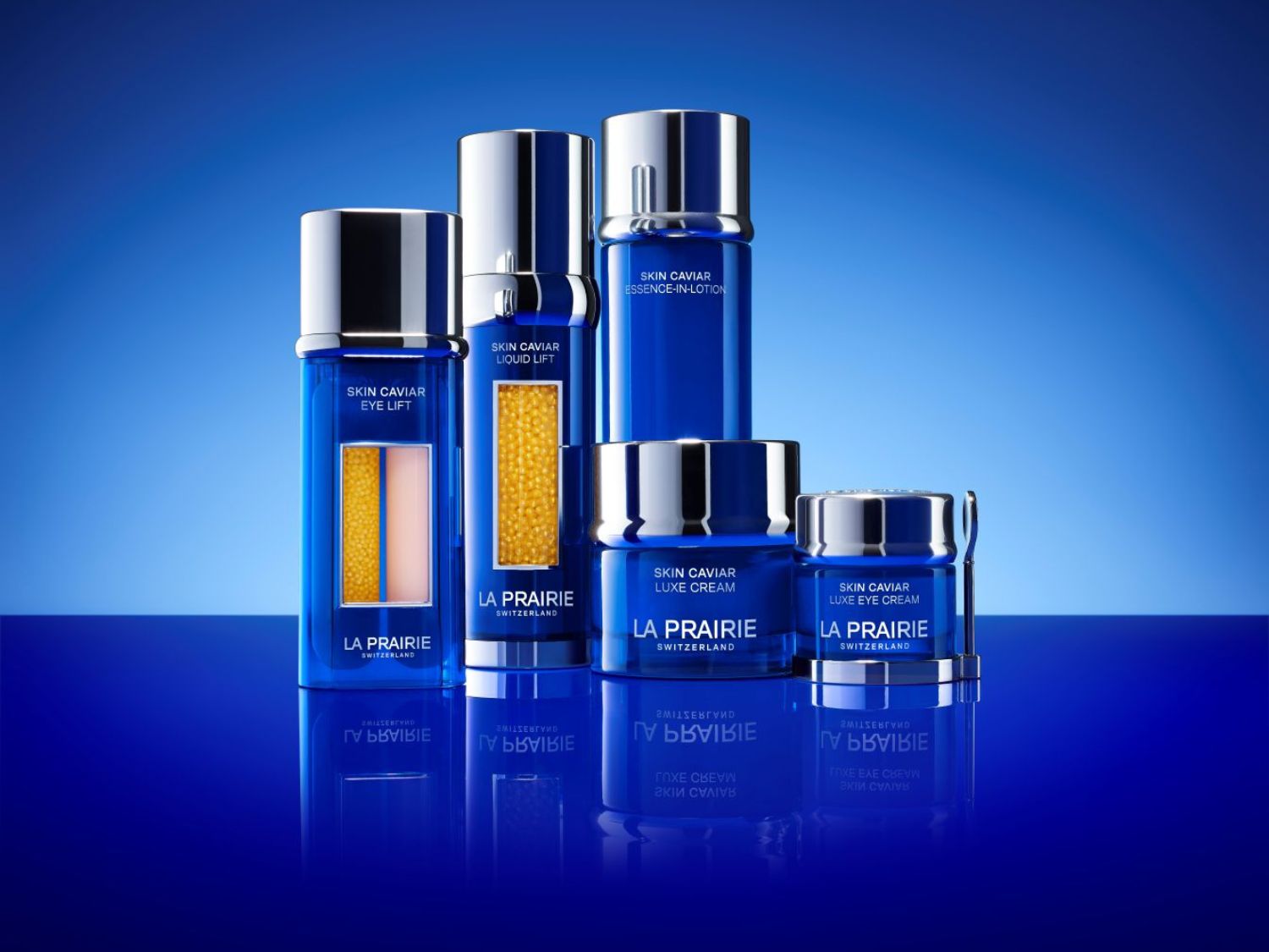 Kolekcia La Prairie Skin Caviar v modrých obaloch so striebornými detailmi, vrátane Eye Lift, Liquid Lift, Essence-In-Lotion, Luxe Cream a Luxe Eye Cream.