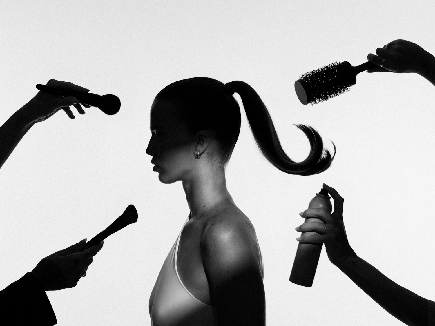 Silhouette einer Frau mit Pferdeschwanz, umgeben von Händen, die Make-up-Pinsel, eine Haarbürste und Haarspray halten, vor einem hellen Hintergrund.