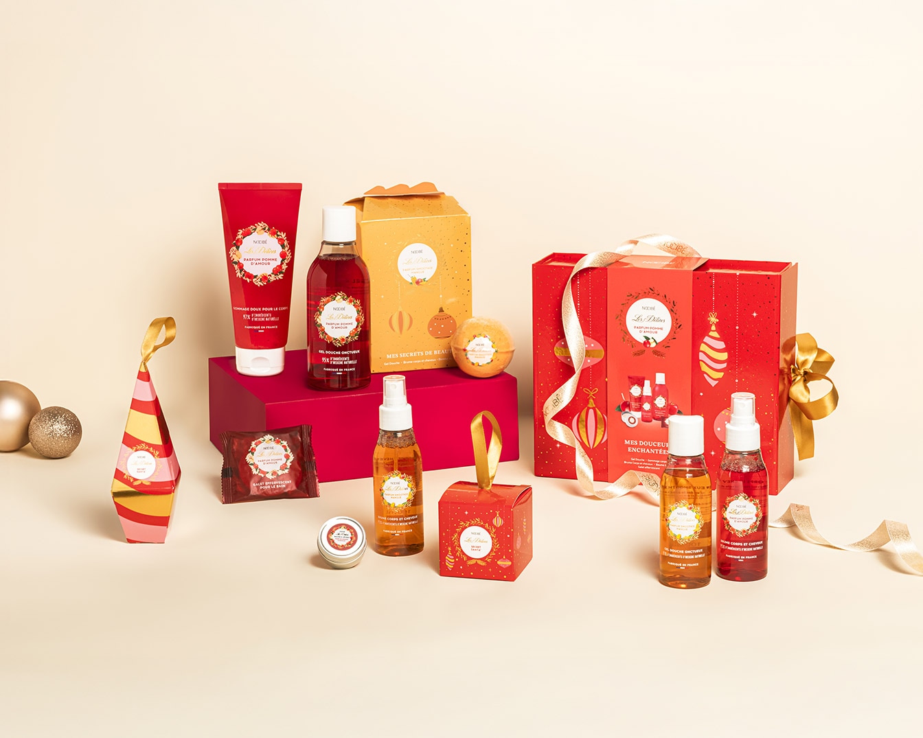 Découvrez un assortiment de produits de bain et de soins corporels Nocibé, présentés dans des emballages festifs rouges et dorés, parfaits pour offrir ou se faire plaisir.