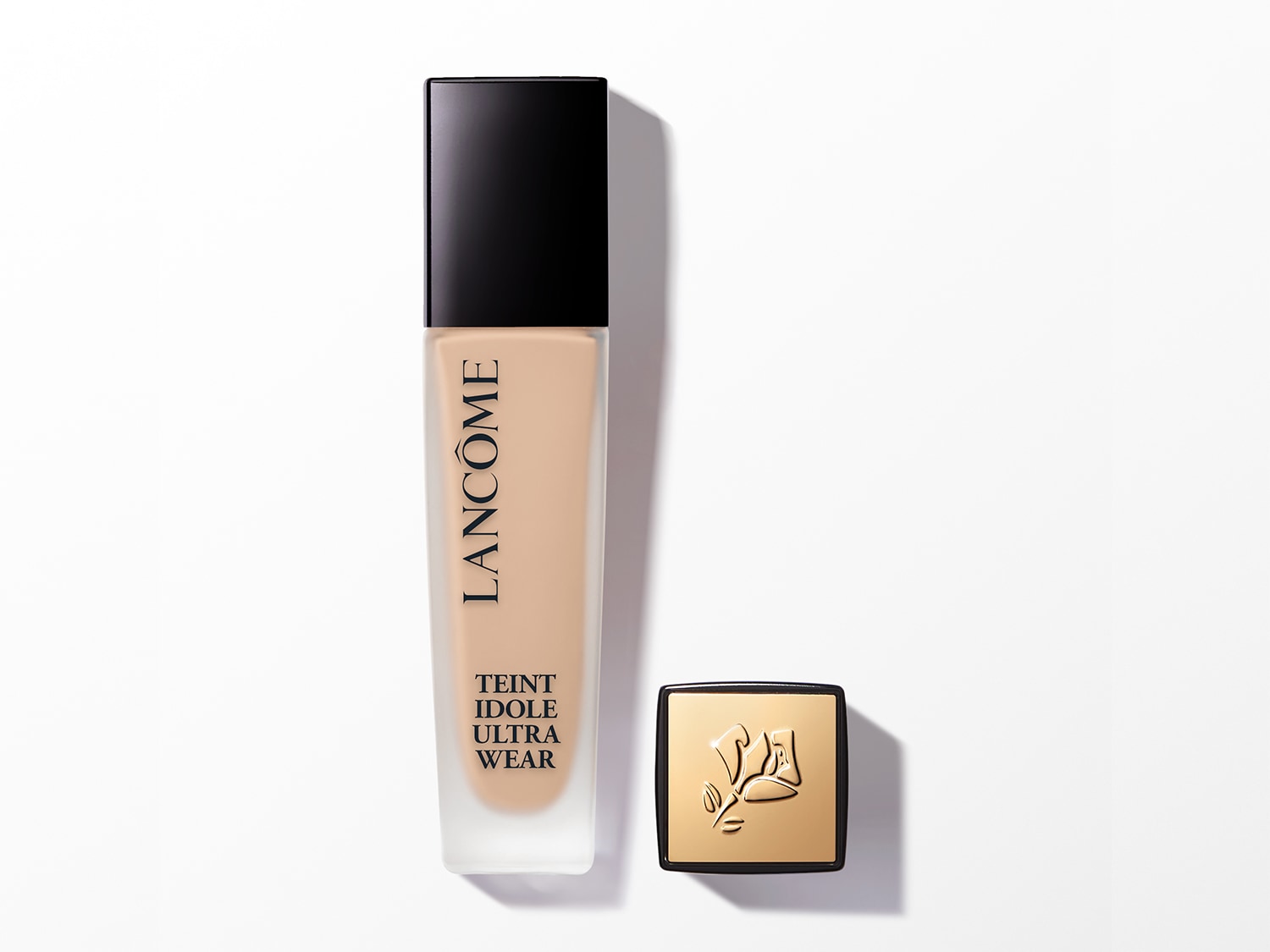Lancôme Teint Idole Ultra Wear Foundation in einer transparenten Glasflasche mit schwarzem Deckel und goldener Kappe mit dem Lancôme-Logo.