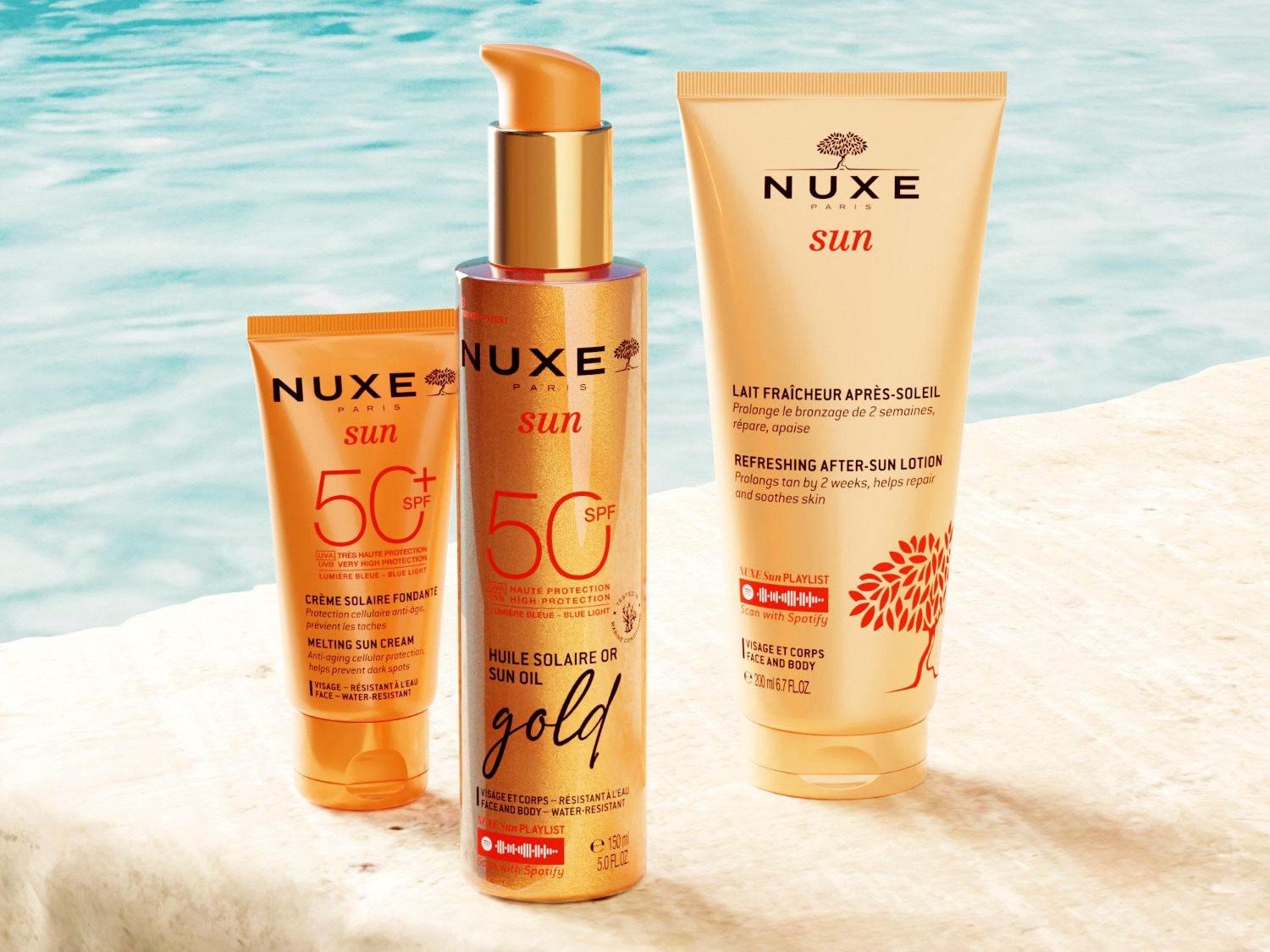 Nuxe Sun collectie met smeltende zonnecrème SPF 50+, gouden zonneolie SPF 50 en verfrissende aftersun lotion, allemaal in oranje verpakkingen.