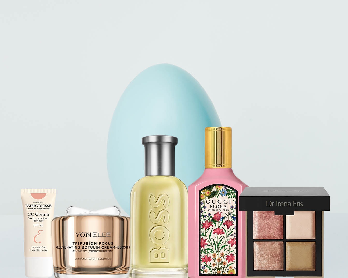 Różnorodność produktów do pielęgnacji i makijażu: krem CC Embryolisse, krem Yonelle, perfumy Boss i Gucci Flora oraz paleta cieni Dr Irena Eris.