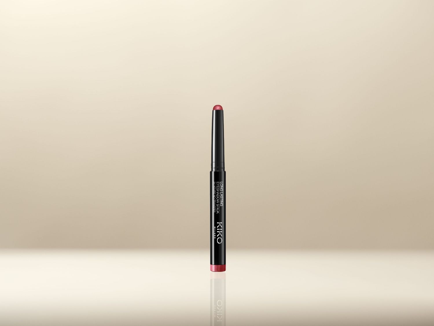 Voici un crayon ombre à paupières Kiko Milano Long Lasting Eyeshadow Stick, dans un emballage noir élégant avec une teinte rose délicate.