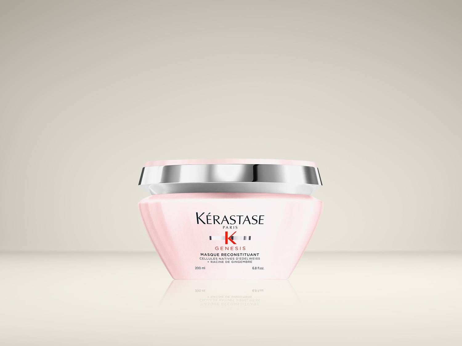 Voici le masque reconstituant Kérastase Genesis, un soin capillaire enrichi en cellules natives d'edelweiss et racine de gingembre, présenté dans un pot rose pâle élégant.