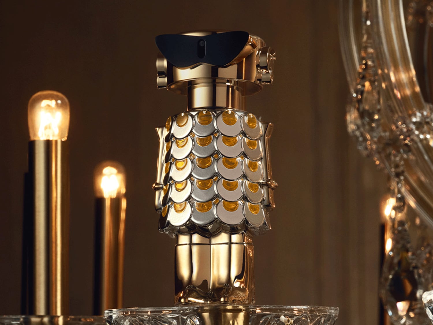 Découvrez le flacon de parfum robotique doré, orné d'écailles argentées et coiffé de lunettes noires futuristes.