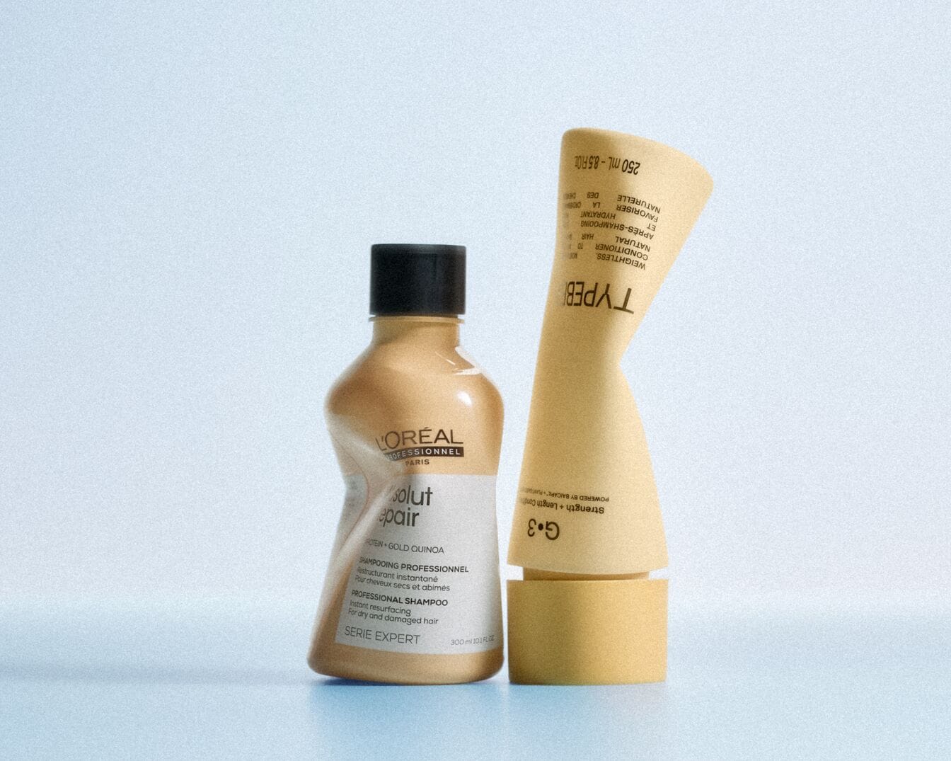  L'Oréal Professionnel Paris Absolut Repair Shampoo in einer gelben Flasche mit schwarzem Verschluss und TYPEB Haarspülung in einer gelben Tube, die für trockenes und geschädigtes Haar entwickelt wurde.