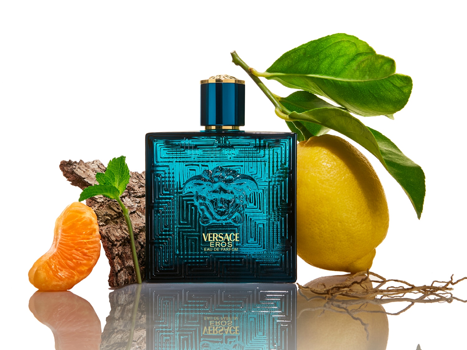 Le parfum Versace Eros Eau de Parfum bleu turquoise est mis en valeur avec des notes fraîches de citron, de mandarine et de menthe, évoquant un parfum méditerranéen.