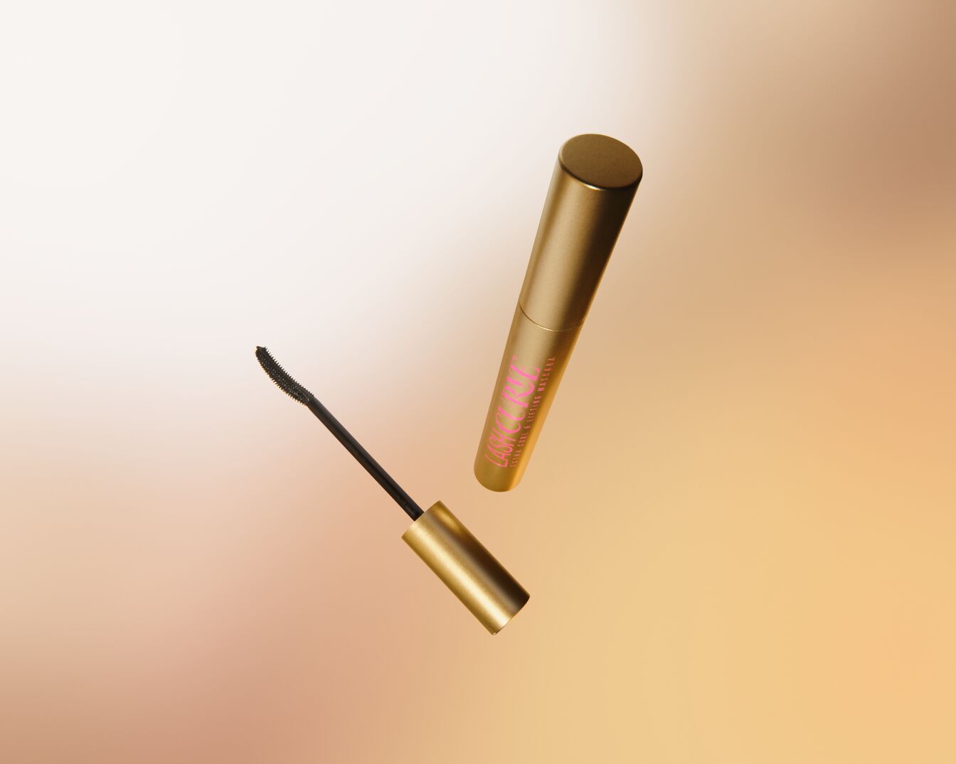 Close-up of a golden mascara tube with pink lettering „Lash Curl Extra Curl & Lifting Mascara“ and a black mascara brush.