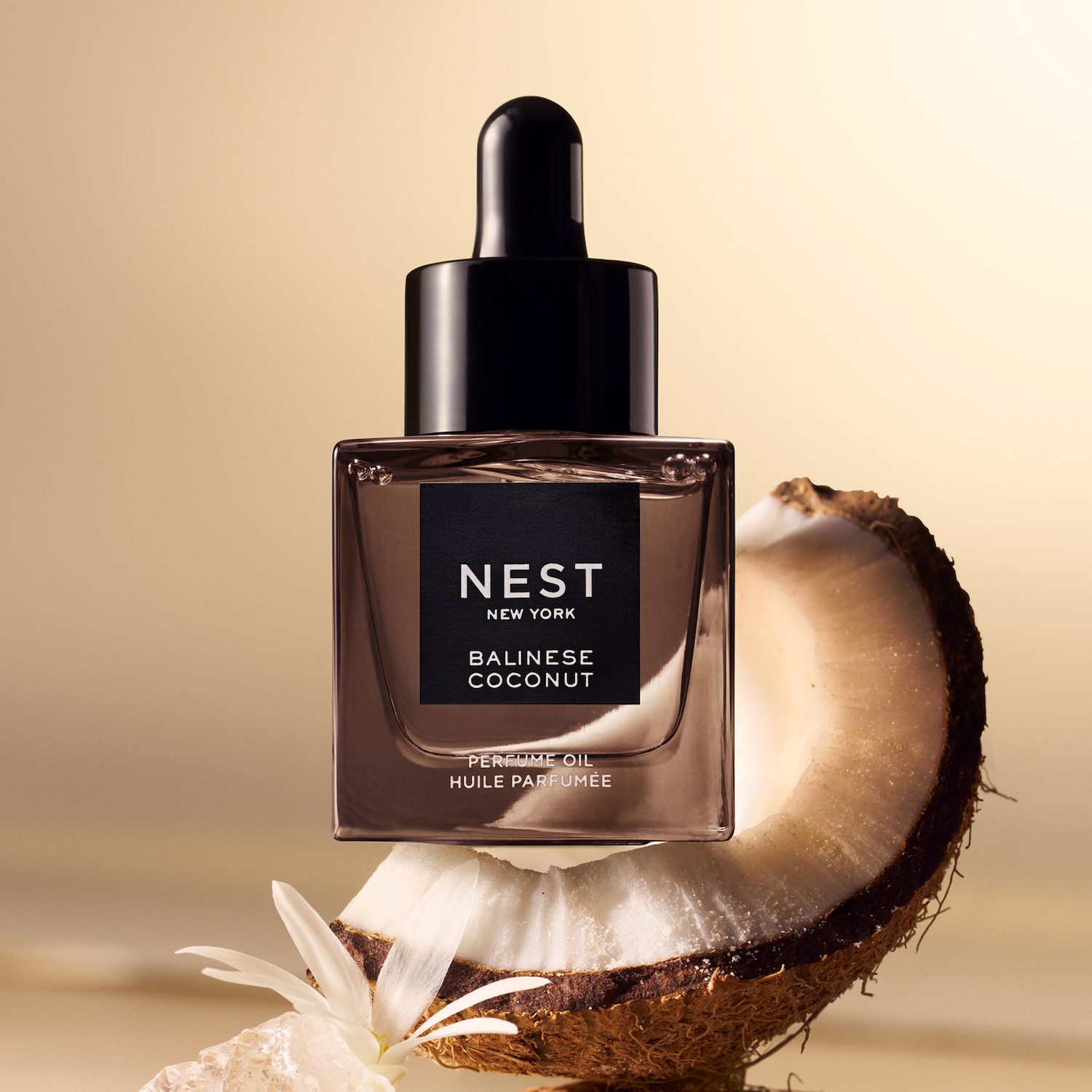 A Nest New York Balinese Coconut parfümolaj egy kókuszdió tetején ül, fekete kupakkal és címkével, amely a trópusi esszenciát idézi.