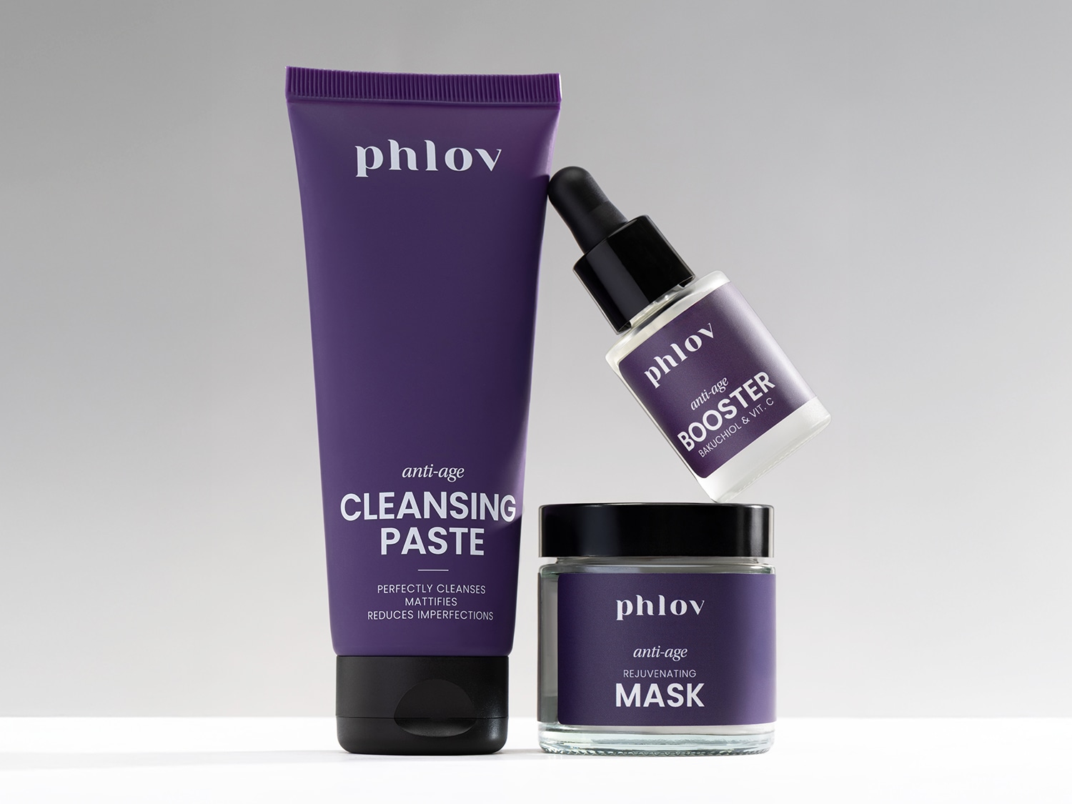 Fioletowy zestaw kosmetyków Phlov do pielęgnacji twarzy obejmuje pastę oczyszczającą, booster i maskę odmładzającą, zapewniając kompleksową pielęgnację anti-age.
