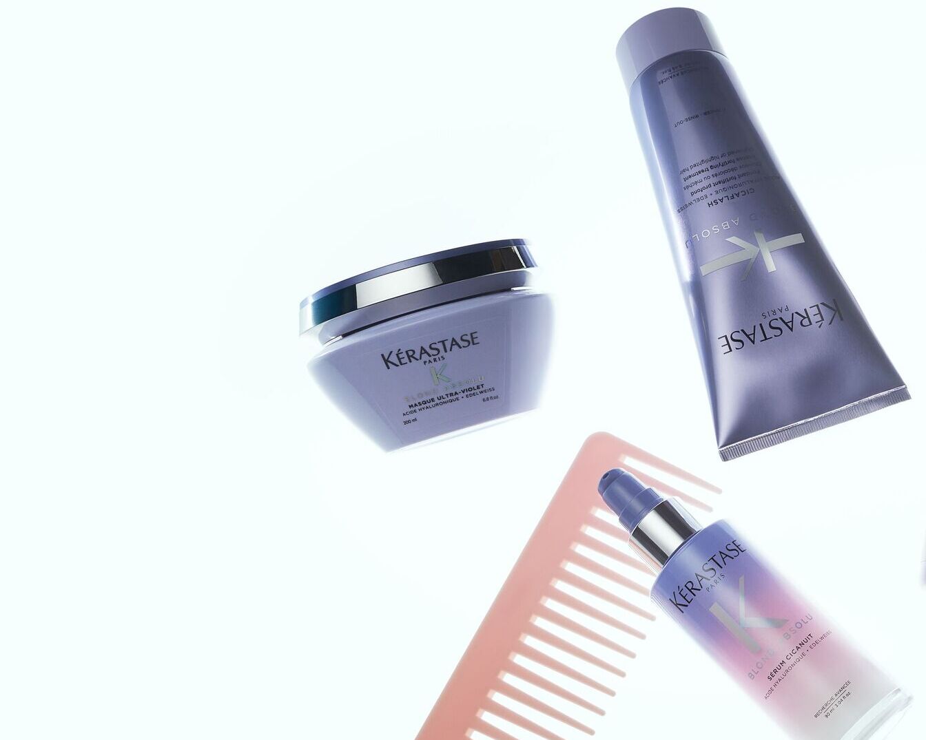 Kérastase Paris plaukų priežiūros priemonių rinkinys violetiniuose buteliukuose ir indeliuose, skirtas šviesiems plaukams puoselėti.