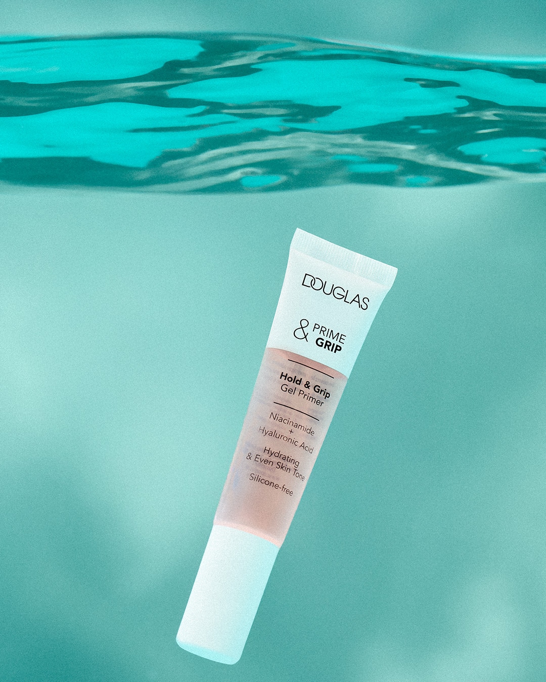 Ecco due primer: Huda Beauty Easy Blur in confezione nera e Douglas Prime & Grip in confezione bianca e trasparente, entrambi promettono una base liscia e idratante senza siliconi.