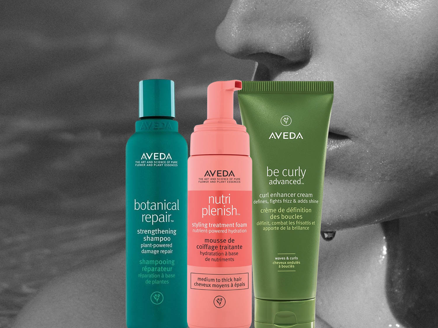 Aveda Botanical Repair strengthening shampoo in a green bottle and Aveda Scalp Solutions exfoliating scalp treatment in a light green tube, set against a soft floral background.