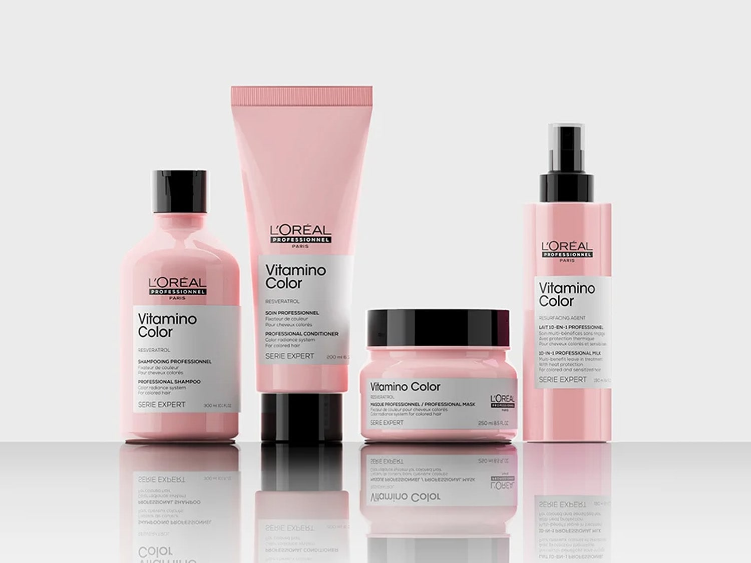 Różowa seria kosmetyków L’Oréal Professionnel Vitamino Color do włosów farbowanych, obejmująca szampon, odżywkę, maskę i mleczko w sprayu.