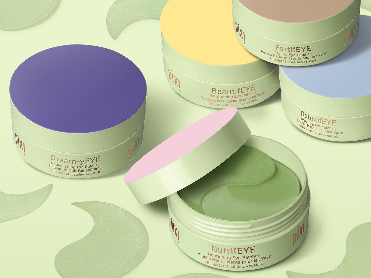 Różnokolorowe opakowania Pixi z płatkami pod oczy: fioletowe Dream-yEYE, żółte BeautifEYE, beżowe FortifEYE, niebieskie DetoxifEYE i zielone NutrifEYE, oferujące różne korzyści dla skóry.