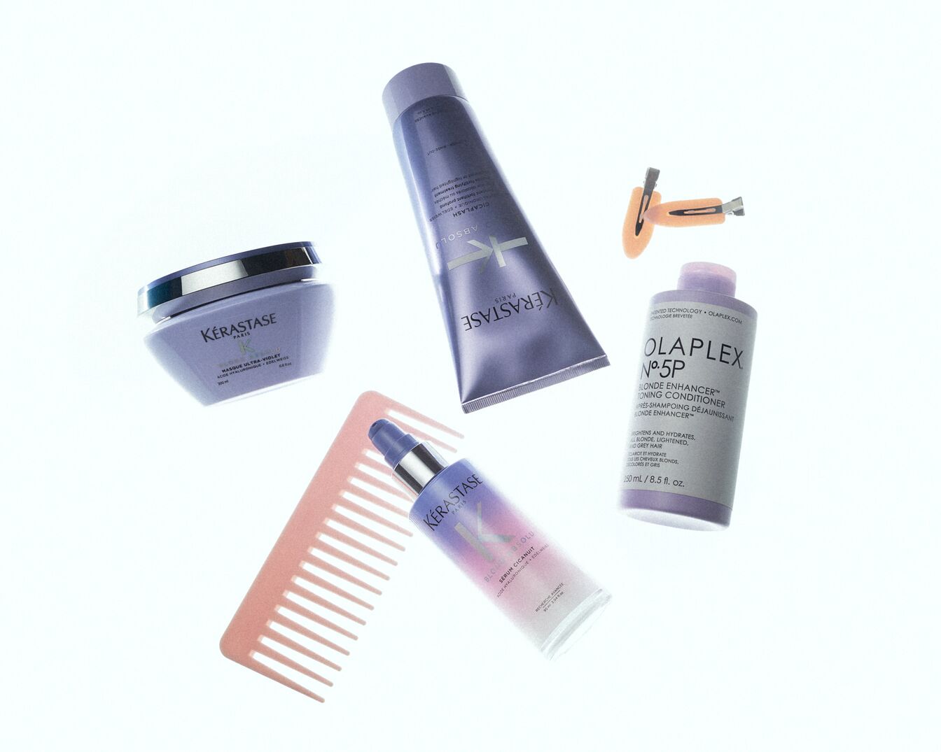 Ontdek een collectie haarverzorgingsproducten, waaronder Kérastase en Olaplex, in paarse verpakkingen, perfect voor blond en grijs haar.