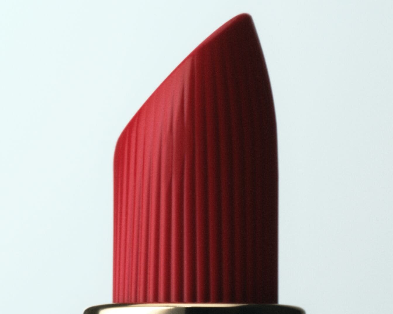 Gros plan sur un rouge à lèvres rouge vif avec une texture lisse et crémeuse, parfait pour ajouter une touche de couleur audacieuse à votre look.