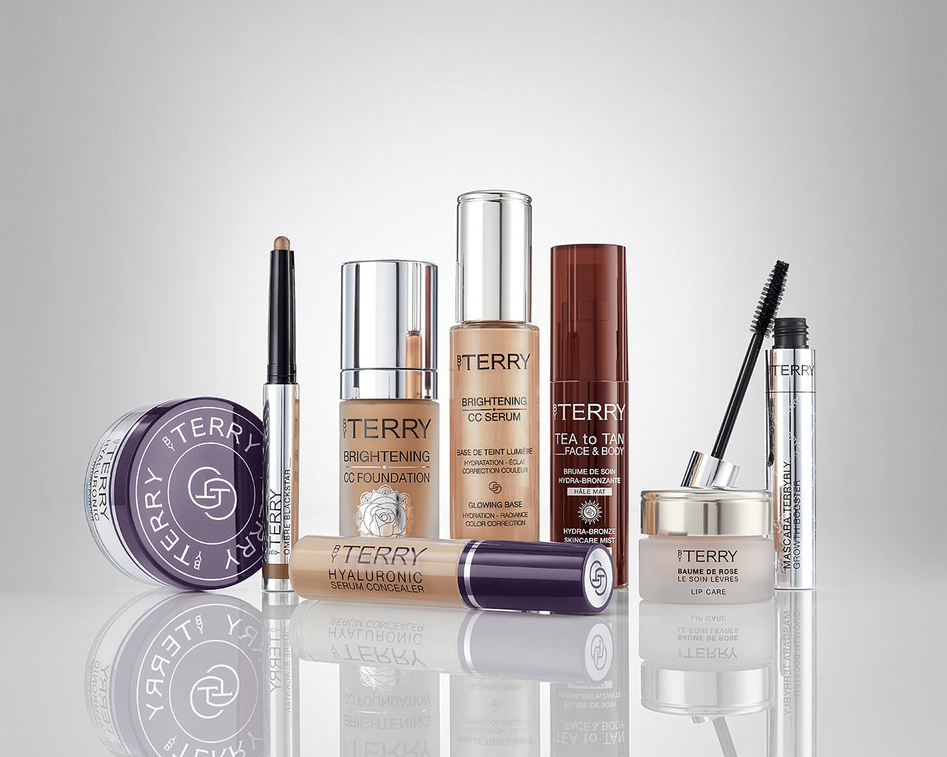 Kolekcja kosmetyków By Terry obejmuje podkład CC, serum, korektor, bronzer w sprayu, tusz do rzęs i balsam do ust, zapewniając kompleksowy makijaż.