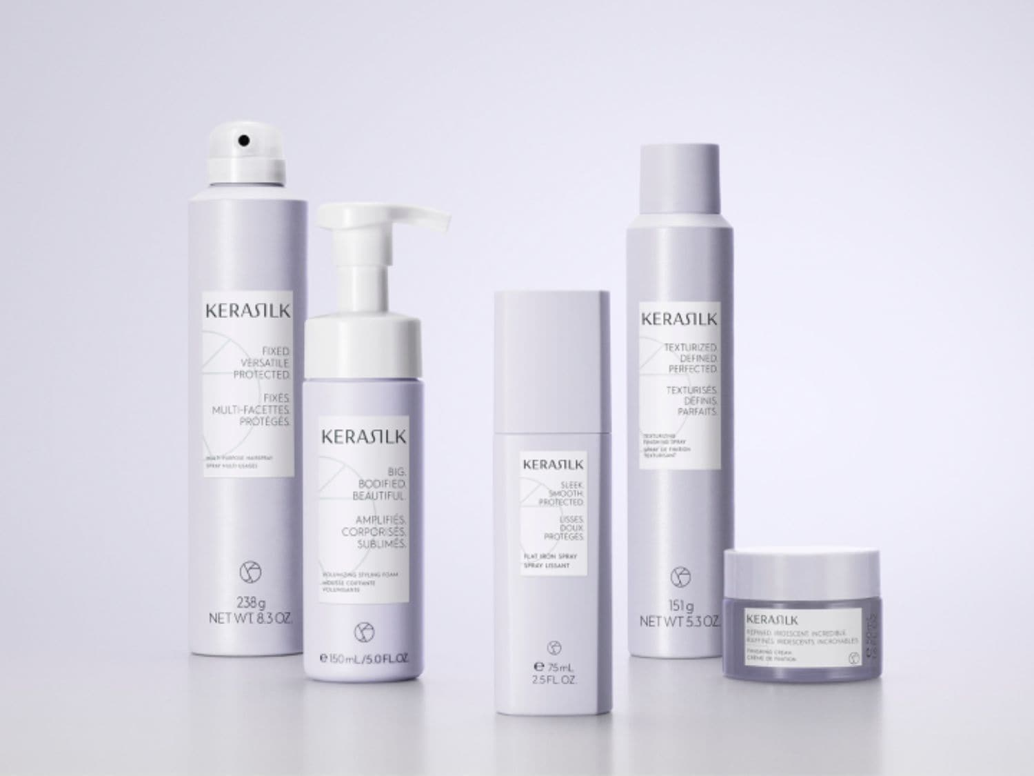 Een reeks paars getinte Kerasilk haarverzorgingsproducten, waaronder styling foam, haarspray en finishing cream, beloven fixatie, volume en textuur voor prachtig haar.