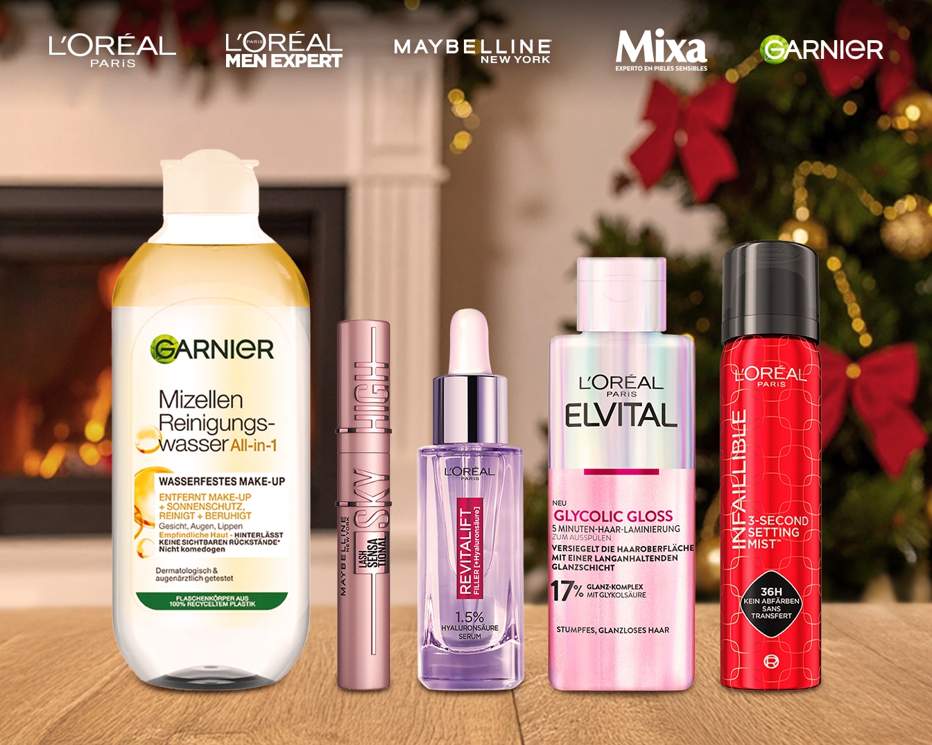 Fünf Beauty-Produkte vor weihnachtlichem Hintergrund, darüber die Markenlogos von L'Oreal Paris, L'Oréal Paris Men Expert, Maybelline New York, Mixa und Garnier.