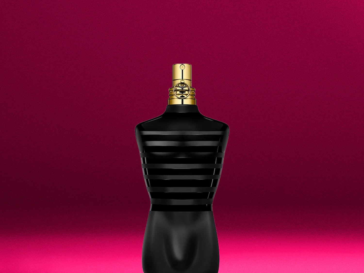 Schwarzer Flakon in Form eines Männeroberkörpers mit goldenem Verschluss vor einem pinkfarbenen Hintergrund.