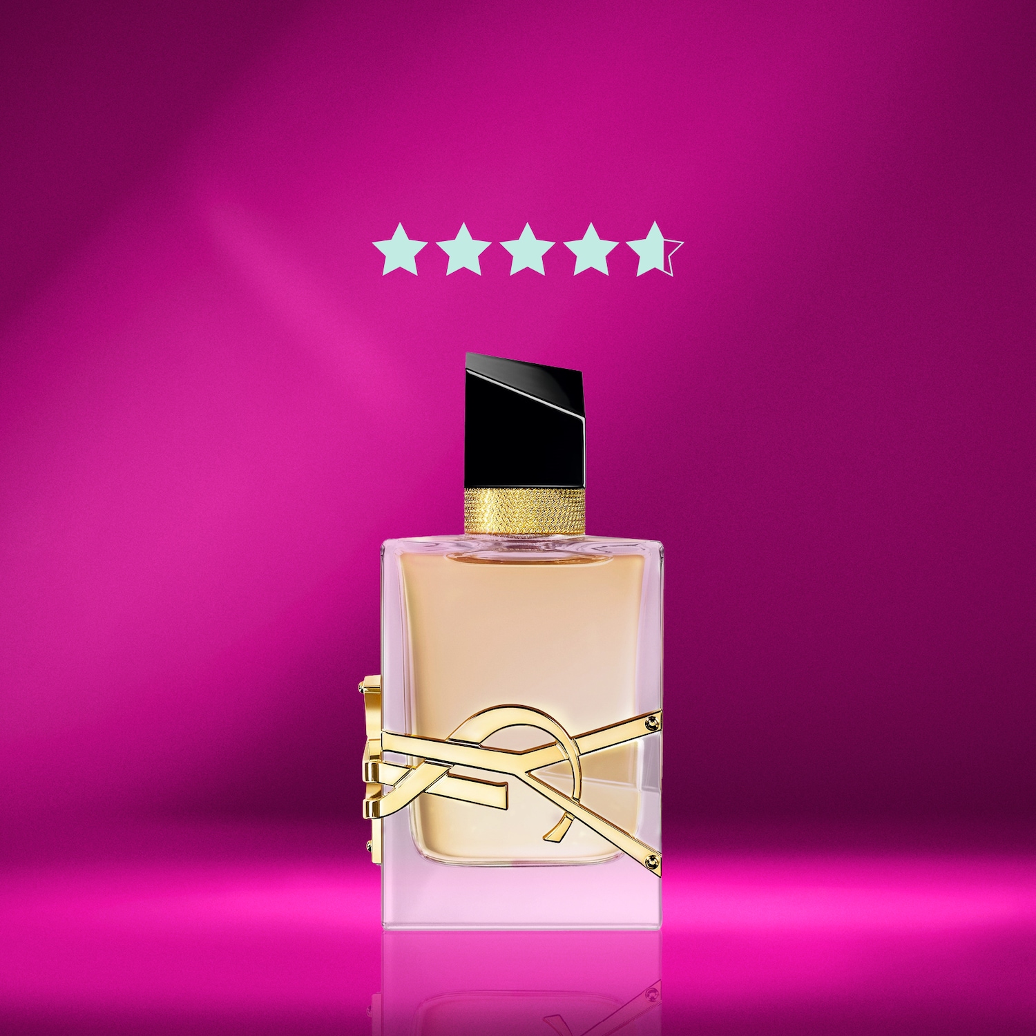 Le parfum Yves Saint Laurent, un flacon rectangulaire élégant avec un logo doré distinctif, est mis en valeur sur un fond rose vif, surmonté de cinq étoiles turquoise.