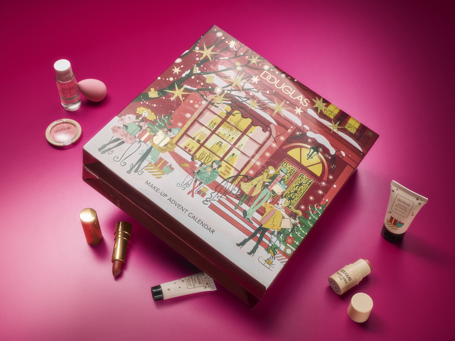 Šventinis „Douglas“ makiažo advento kalendorius su iliustracijomis ir įvairiais makiažo produktais, tokiais kaip lūpų dažai, skaistalai ir kremai.