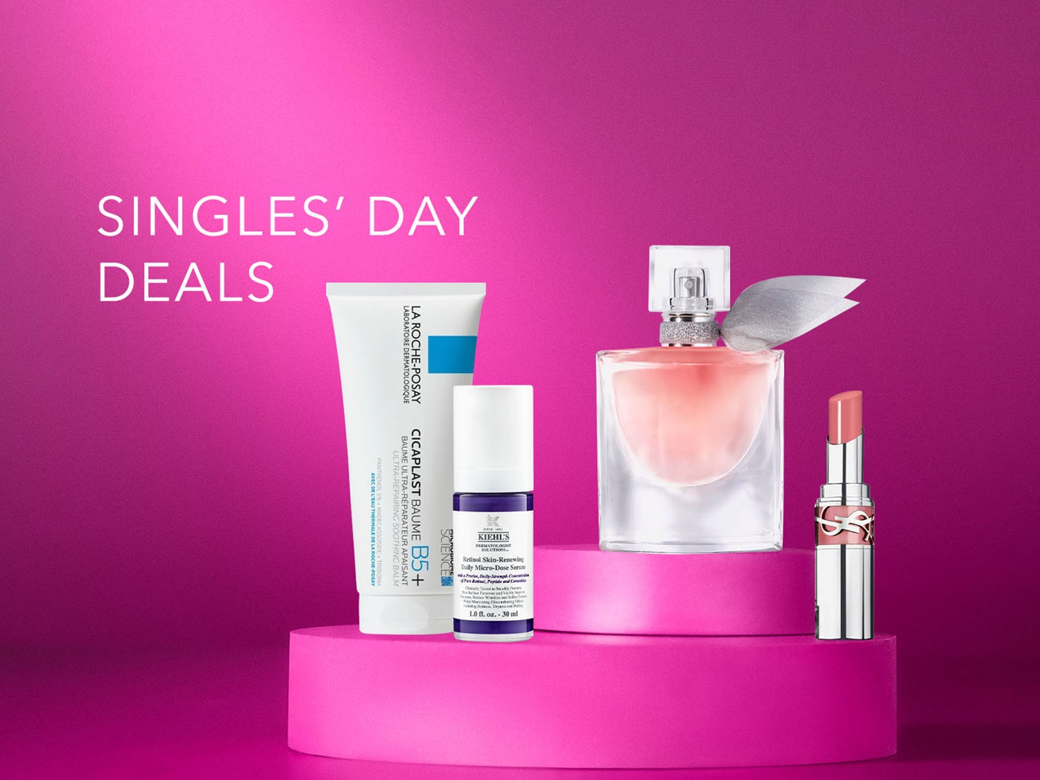 Découvrez les offres exclusives de la Singles' Day avec des produits de soin La Roche-Posay, Kiehl's, un parfum élégant et un rouge à lèvres YSL, le tout présenté sur un fond rose vibrant.