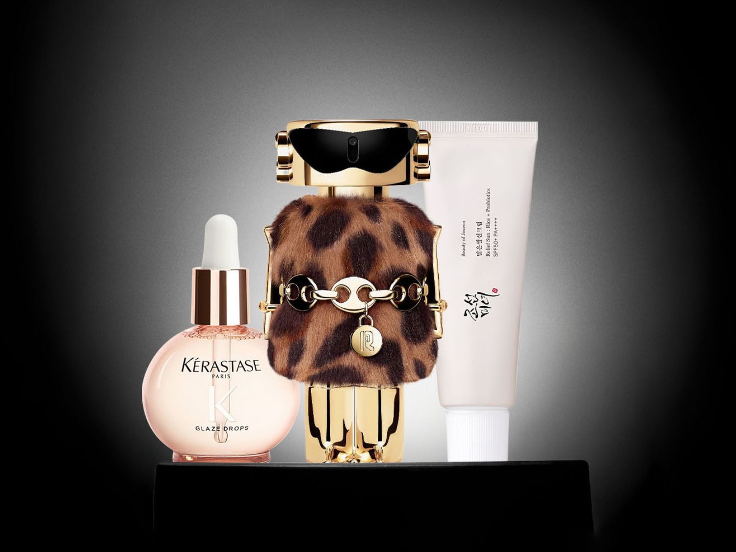 Ontdek de Kérastase Glaze Drops voor glanzend haar, de Beauty of Joseon zonnebrandcrème met SPF50+ en een parfumfles in de vorm van een gouden figuur met een luipaardjas.