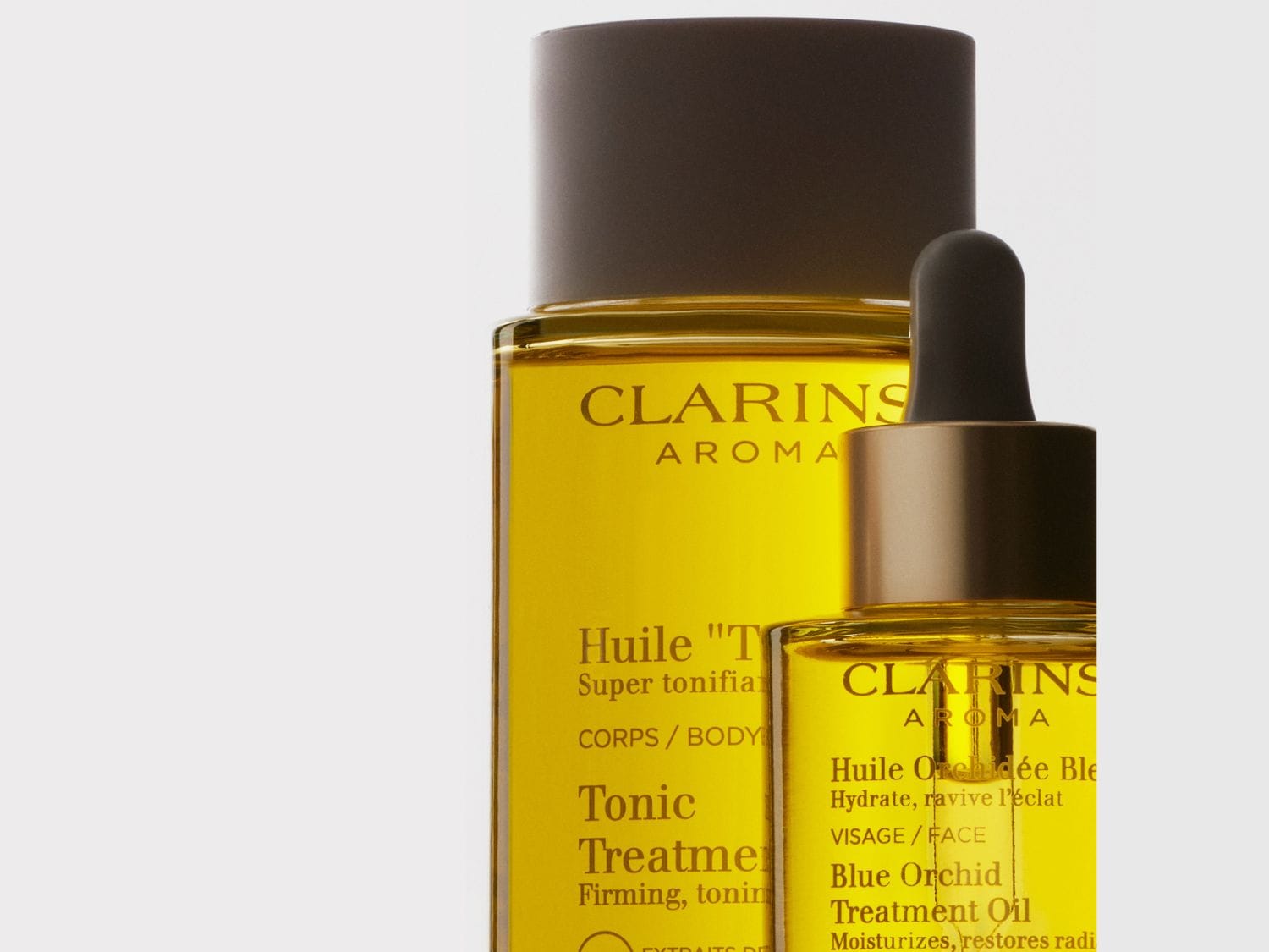 Découvrez l'huile tonique Clarins Aroma pour le corps et l'huile Orchidée Bleue pour le visage, des soins qui hydratent et revitalisent votre peau.