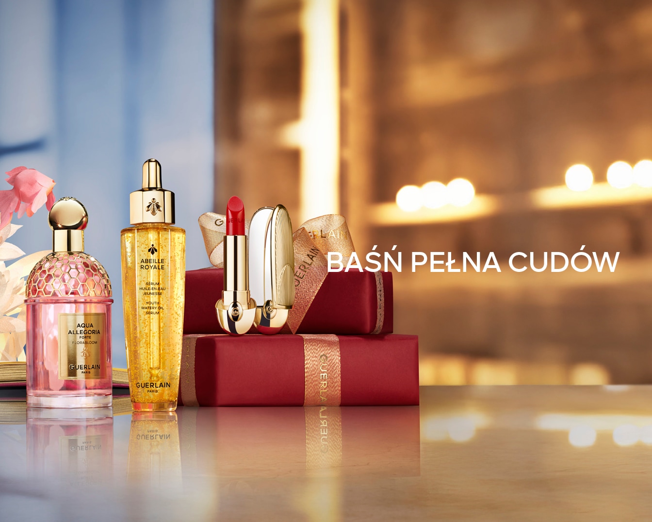 Elegancki zestaw Guerlain z perfumami Aqua Allegoria, serum Abeille Royale i szminką w złotym opakowaniu, idealny na prezent. Baśń Pełna Cudów.