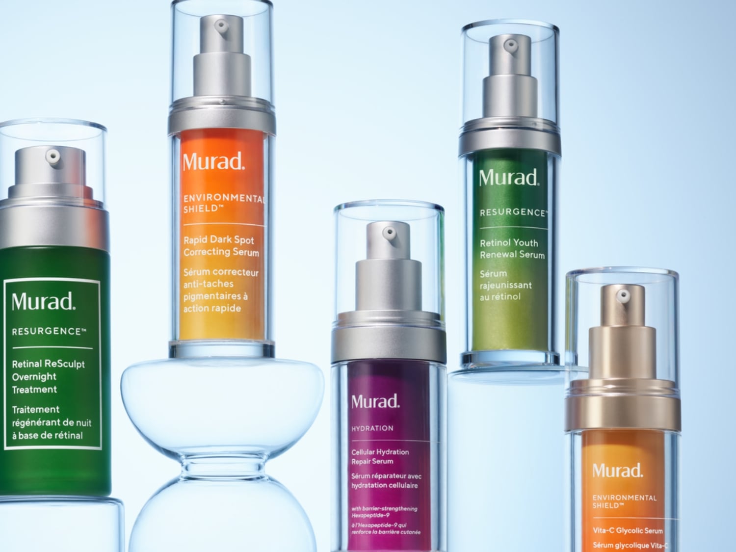 Prezentacja różnych serum Murad w przezroczystych butelkach z pompkami, w odcieniach zieleni, pomarańczy, fioletu i złota, obiecujących pielęgnację skóry.