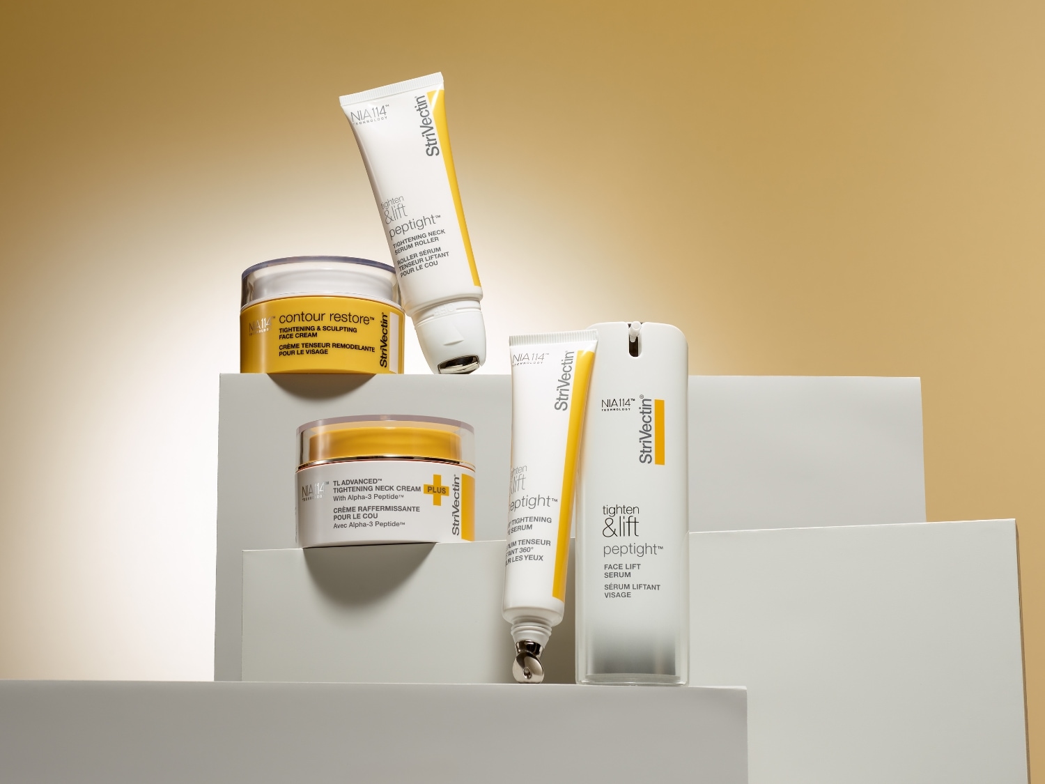 Kolekcja kremów i serum StriVectin z linii Tighten & Lift oraz Contour Restore, w białych i żółtych opakowaniach, obiecujących napięcie i rzeźbienie skóry twarzy i szyi.