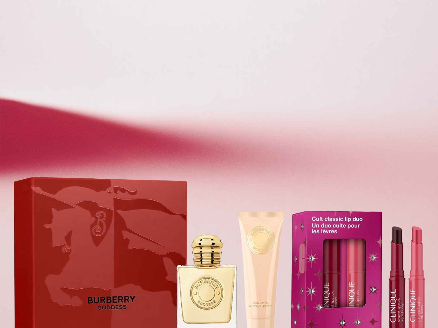 Confezione regalo Burberry Goddess color rosso lucido, con profumo dorato e set labbra Clinique 'Cult classic lip duo' nei toni del rosa e del miele.