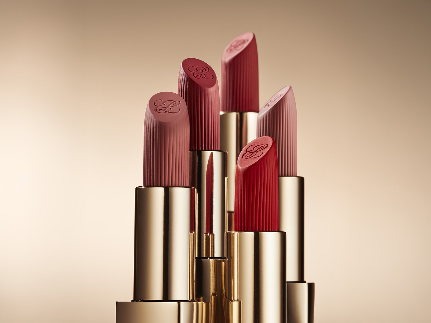 Découvrez une collection de rouges à lèvres aux teintes riches, présentés dans des étuis dorés élégants, parfaits pour rehausser votre beauté.