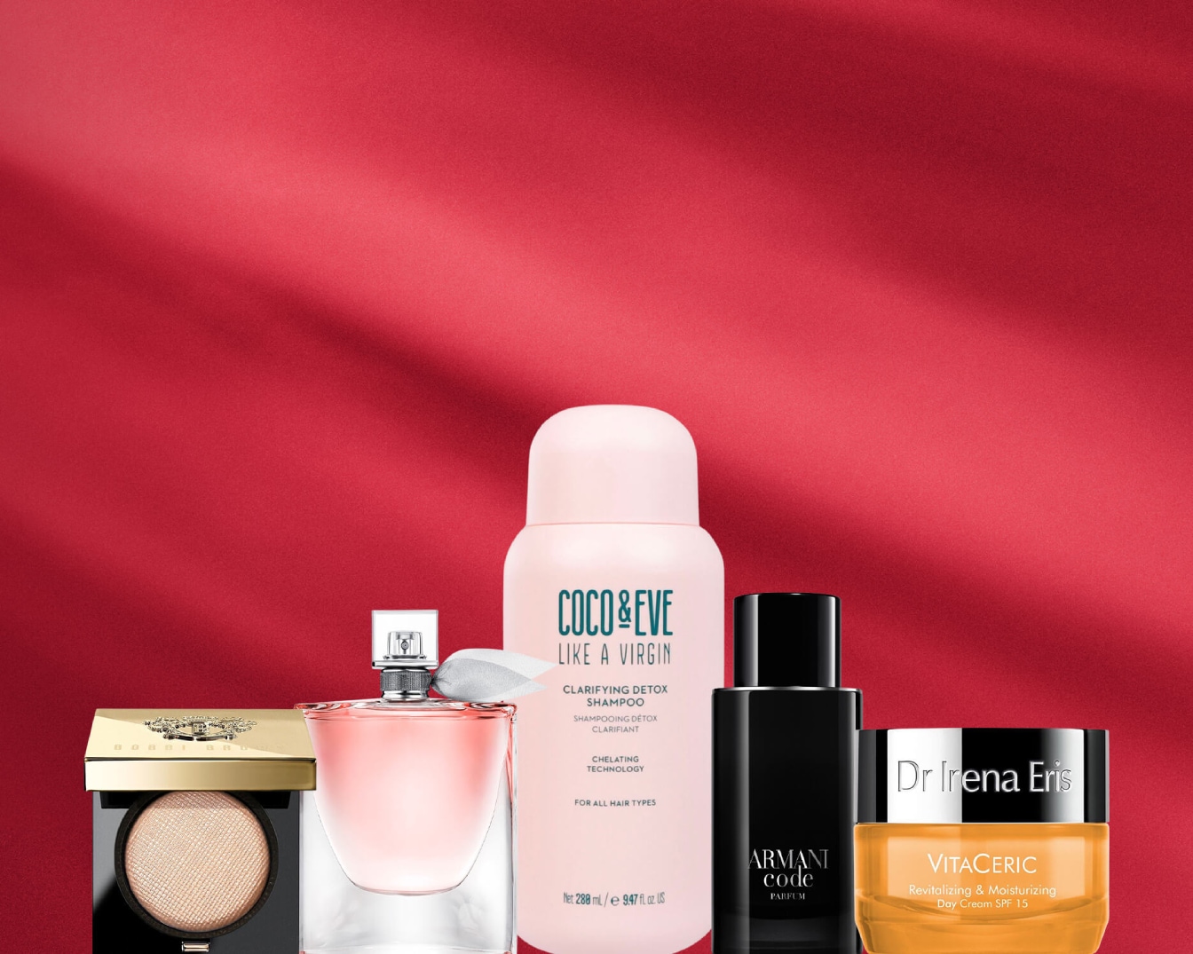 Na czerwonym tle znajdują się produkty do pielęgnacji włosów i skóry, w tym szampon Coco&Eve, perfumy Armani Code i krem Dr Irena Eris.