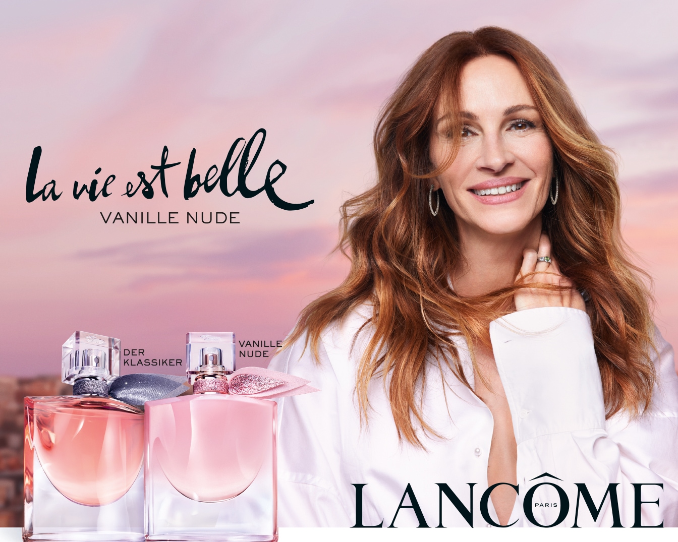 Julia Roberts präsentiert Lancôme La Vie Est Belle Vanille Nude, ein Parfüm in einem rosa Flakon mit silberner Schleife, das die Freude am Leben feiert.