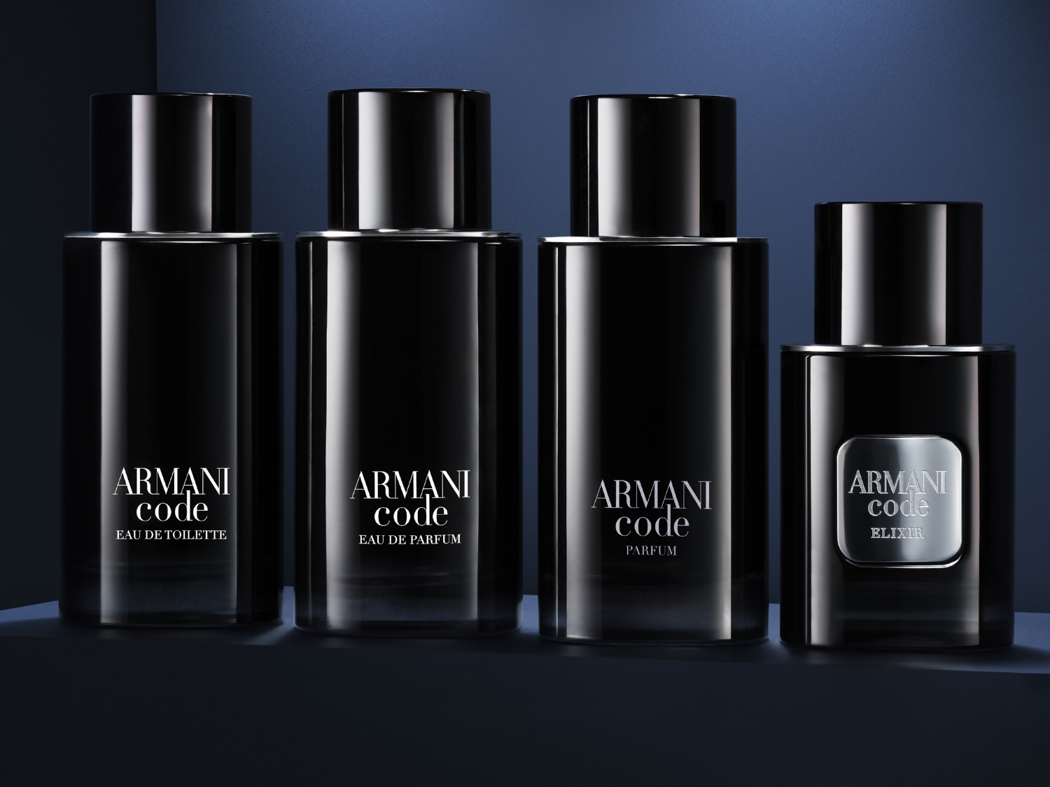 Négy Armani Code parfümös üvegcsét mutat a kép, köztük Eau de Toilette, Eau de Parfum, Parfum és Elixir változatokat, elegáns fekete csomagolásban.