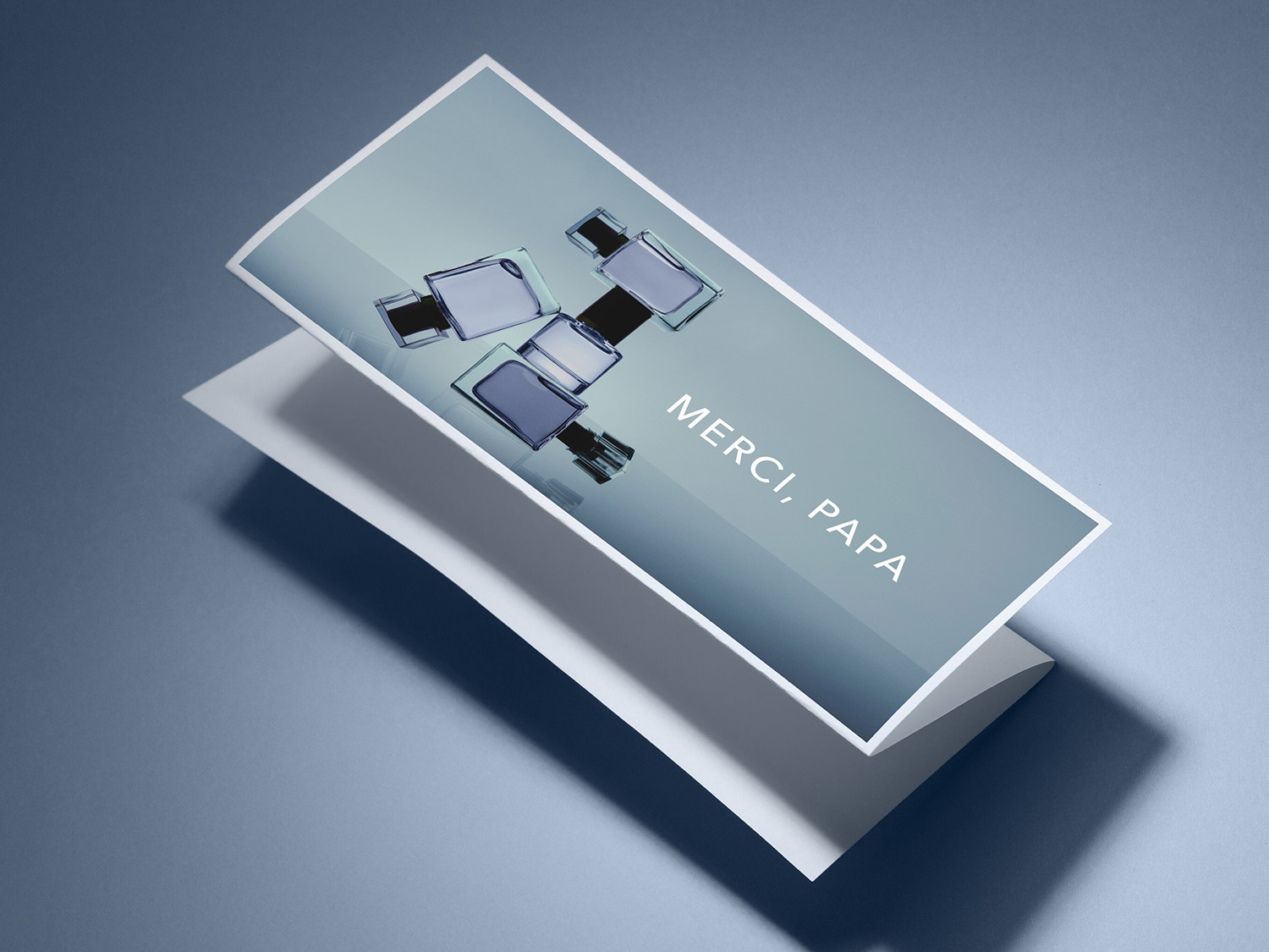 Une carte de vœux rectangulaire blanche avec un dégradé de bleu et des flacons de parfum, avec le texte "MERCI, PAPA" en blanc.