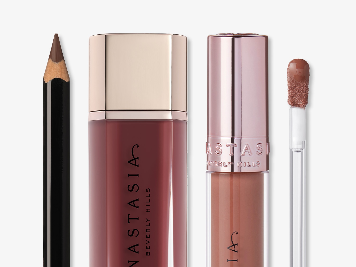 Anastasia Beverly Hills lip set includes a dark brown lip liner pencil, a dark red lipstick with a gold cap, and a light brown lip gloss with a rose gold cap and applicator.