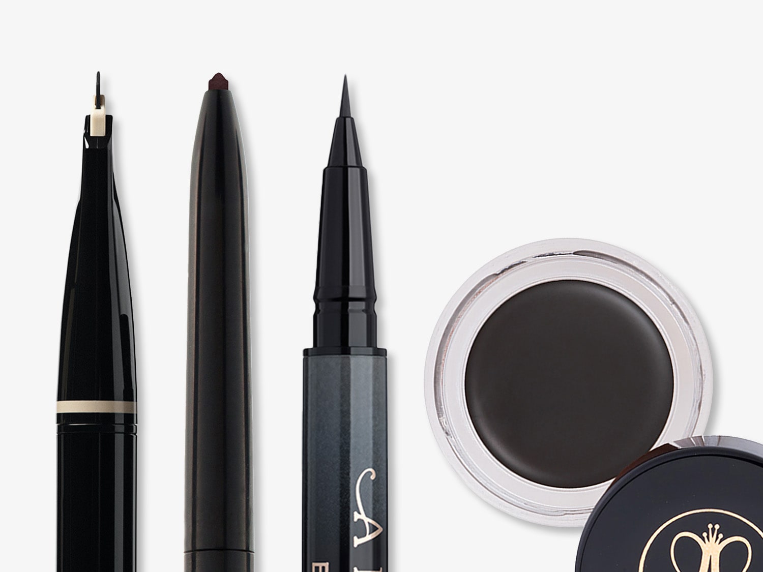 Collection of Anastasia Beverly Hills makeup products including black eyeliner pens with fine tips and a pot of dark brown brow pomade with a clear lid.