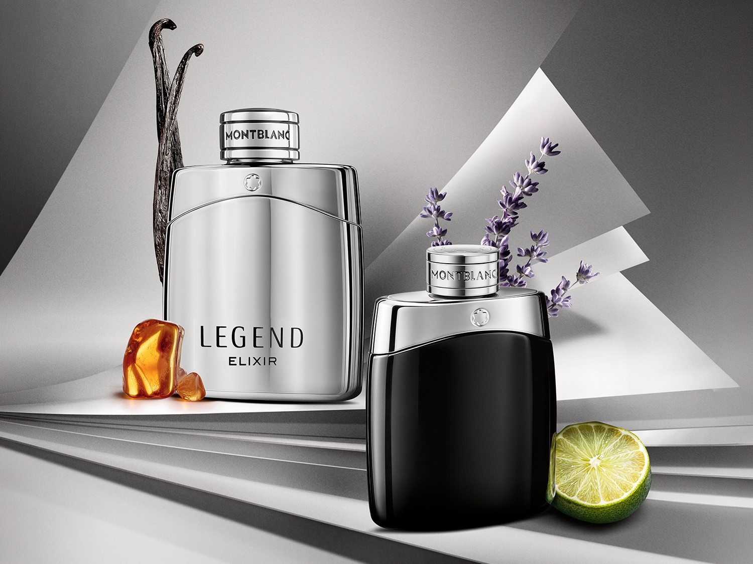 Dwa flakony perfum Montblanc Legend Elixir: srebrny z nutą wanilii i bursztynu oraz czarny z limonką i lawendą, na tle szaro-białych, geometrycznych kształtów.