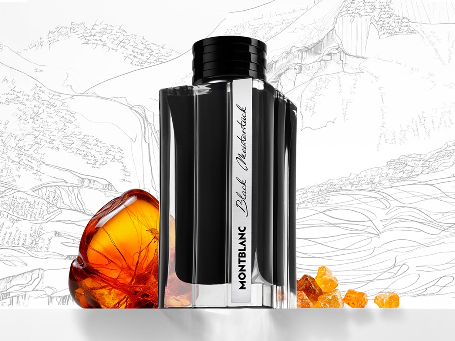Czarny flakon perfum Montblanc Meisterstück z bursztynowymi akcentami na tle szkicu gór.