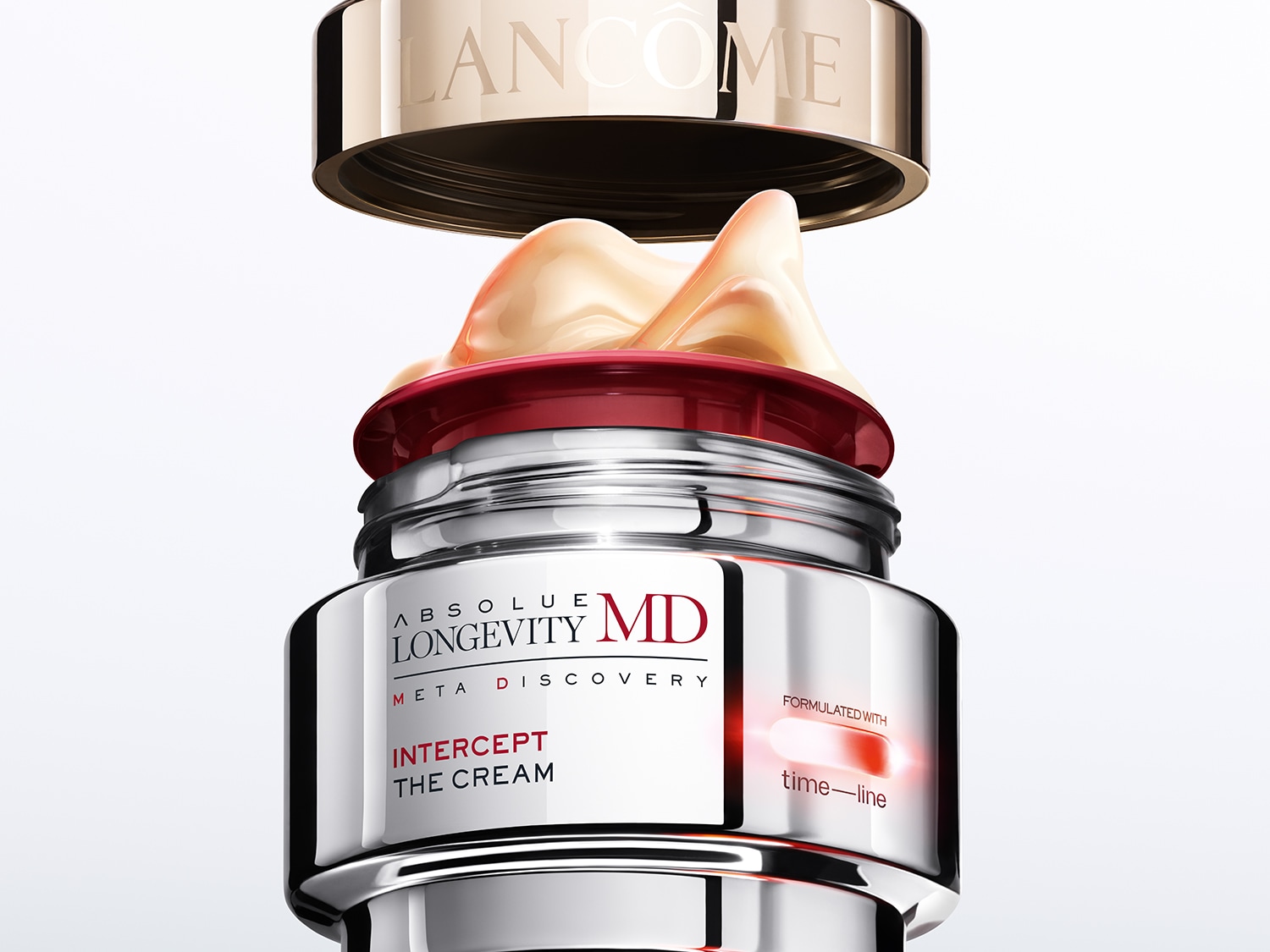 Sidabrinis „Lancôme Absolue Longevity MD Meta Discovery Intercept The Cream“ stiklainis su atidarytu auksiniu dangteliu, atskleidžiančiu kreminės tekstūros turinį.