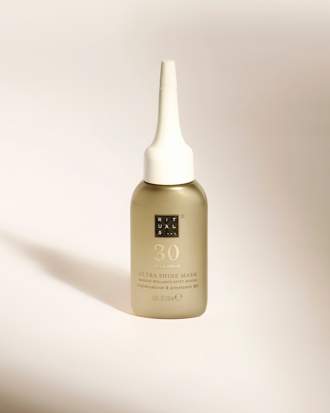 Le masque Ultra Shine 30 Seconds de Rituals, dans un flacon doré mat de 30 ml avec un applicateur blanc, promet une brillance miroir grâce à sa formule enrichie en triple hyaluron et provitamine B5.