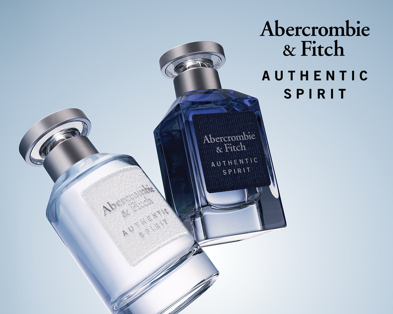 Two Abercrombie & Fitch Authentic Spirit perfume bottles, one with a light liquid and the other with a dark blue liquid, both featuring silver caps and the brand's label.