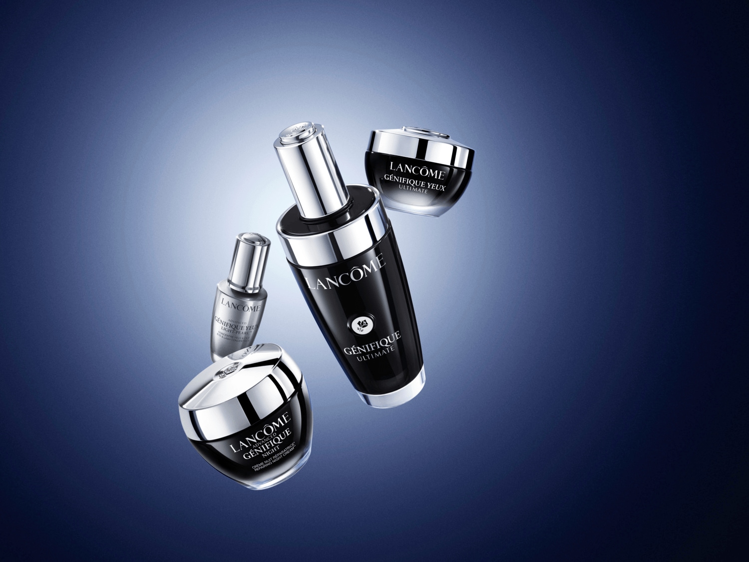 Čtyři produkty péče o pleť Lancôme Génifique, včetně očního krému, nočního krému a séra, v černých a stříbrných obalech.