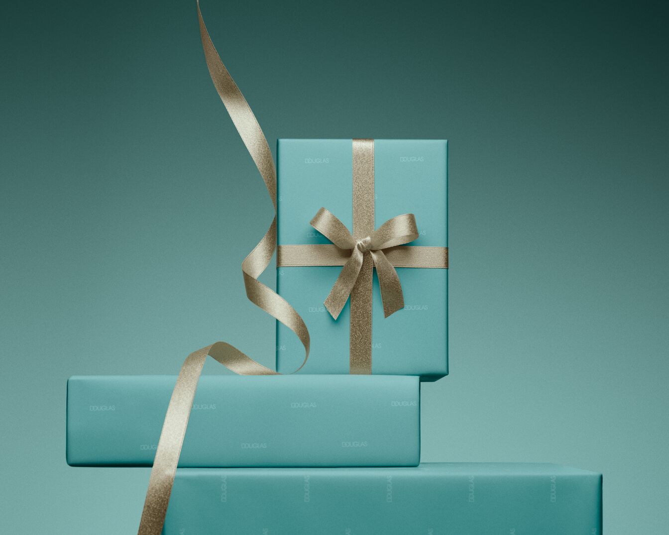 Découvrez une pile de cadeaux Douglas emballés dans du papier bleu-vert et ornés de rubans dorés scintillants, parfaits pour toutes les occasions.
