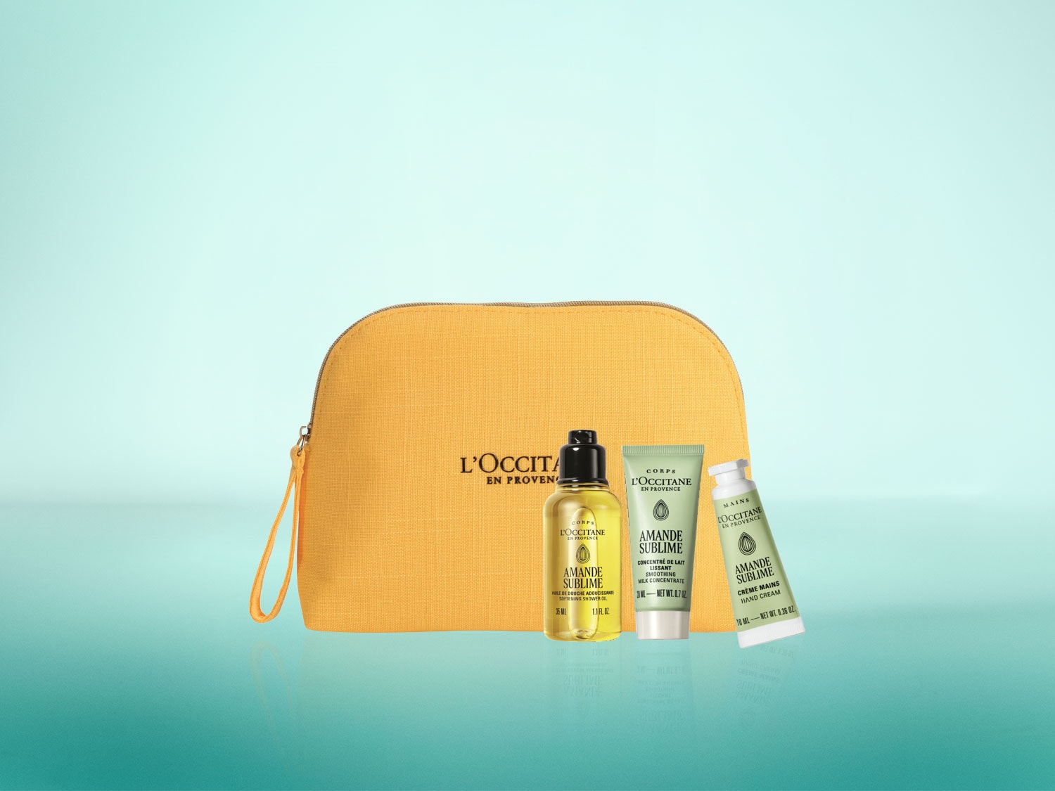 Das L'Occitane Amande Sublime Set enthält ein Duschöl, eine glättende Milch und eine Handcreme in einer gelben Kosmetiktasche, die alle für eine umfassende Hautpflege entwickelt wurden.